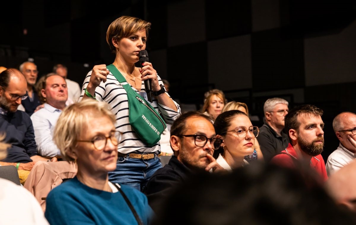Militante MAIF questionnant les dirigeants pendant l'assemblée générale de la mutuelle.